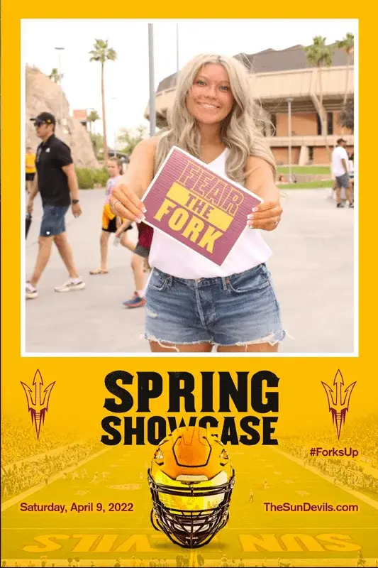 Woman holding a "Fear the Fork" sign at a school event